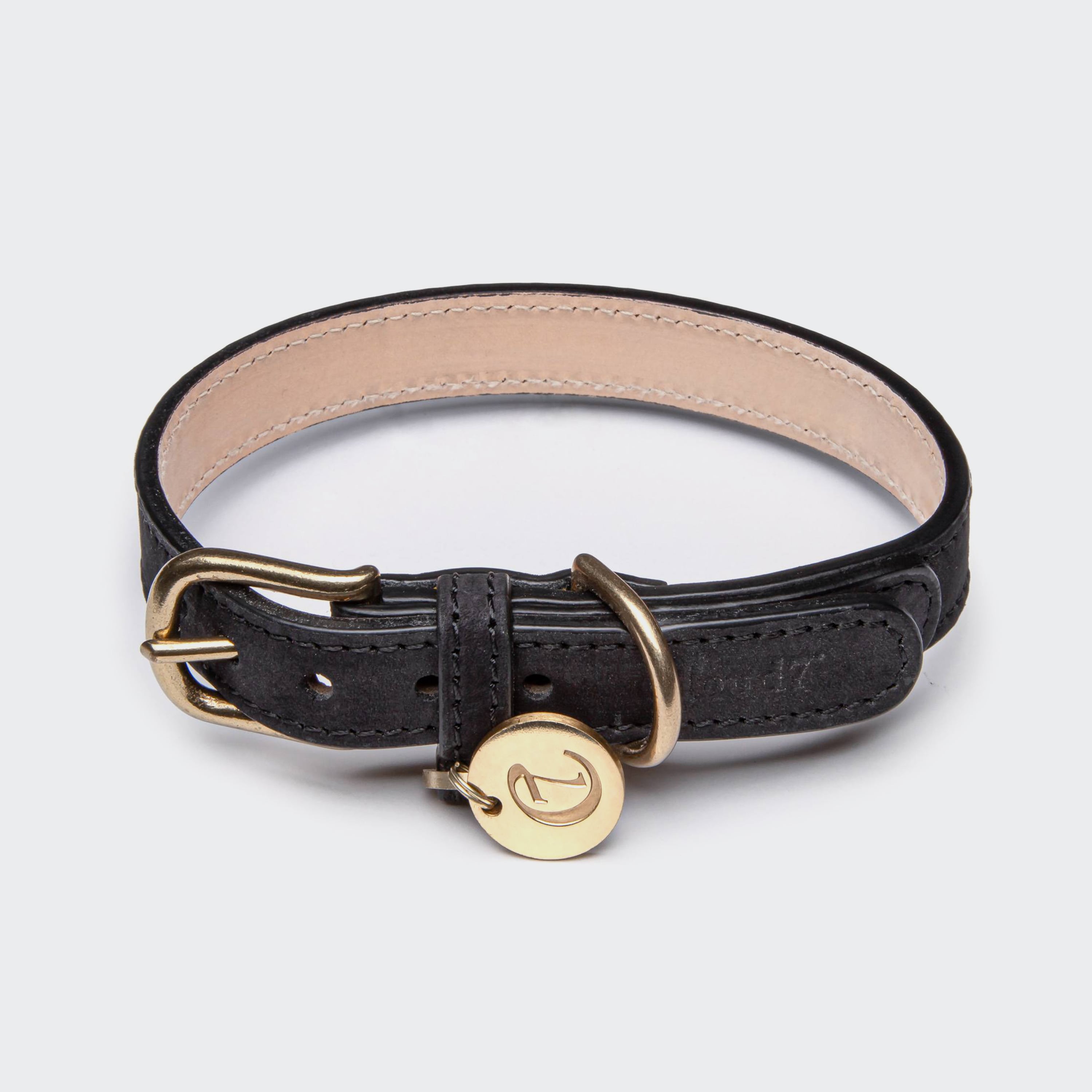 Closed black leather collar for dogs with golden metal elements